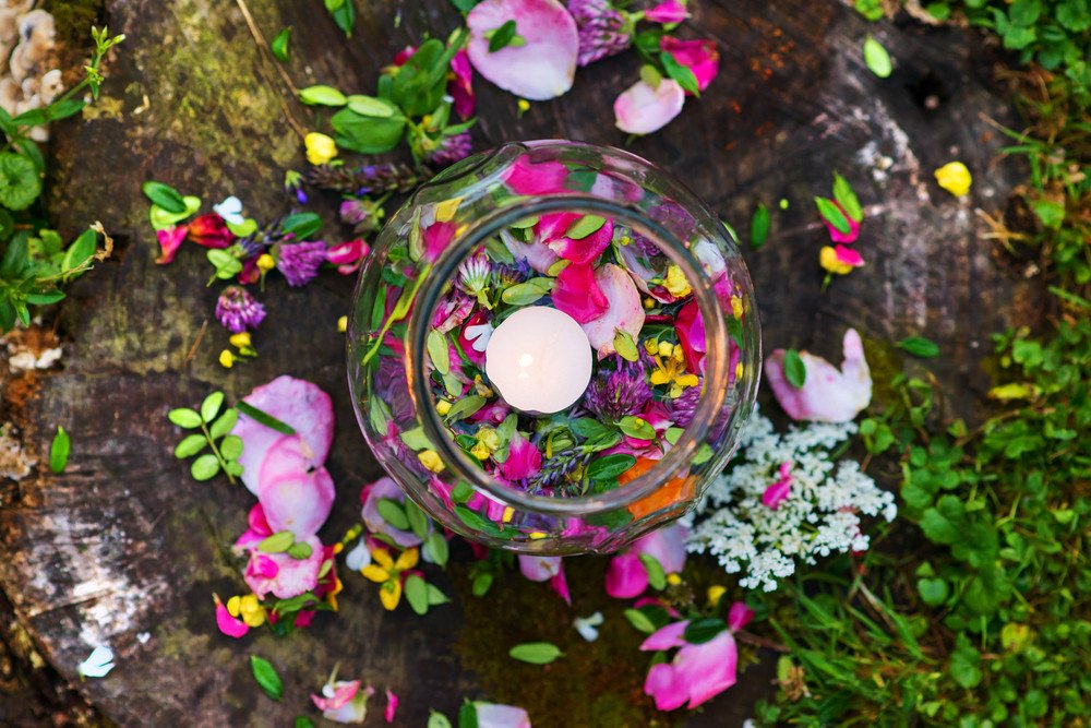 Aromatherapy bowl for relaxing herbal bath with beautiful flower petals and leaves.